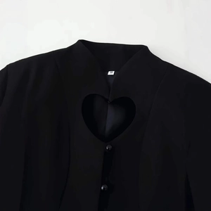 Classic black suit blazer with heart-shaped cutout detail and polished buttons