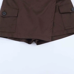 Detailed view of dark coffee wrap skort featuring twill fabric and utility flap pockets