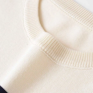 Short-sleeved cream knit top with ribbed crewneck and classic horizontal stripes