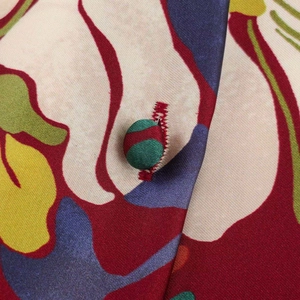 Close-up of fabric texture with floral print and a matching fabric-covered button detail