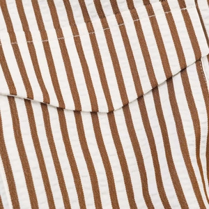 Detail view of brown and white striped seersucker fabric with double-needle stitching