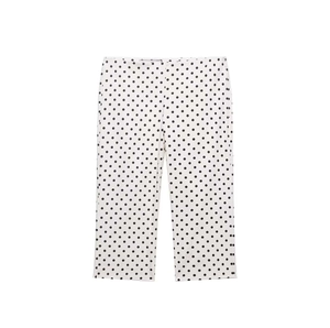 Detail of high-waist white pants with black polka dots featuring a clean straight cut