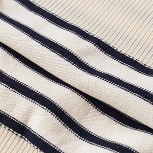 Short-sleeved striped knit top in cream and black featuring ribbed cuffs and soft texture