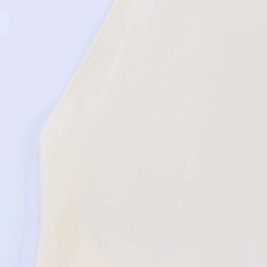 Detail showing high-quality stitching and smooth cream fabric on backless halter top