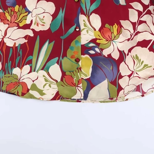 Detail view of burgundy floral satin shirt with buttons and vintage tropical pattern