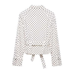 Detailed back view of a white polka dot shirt jacket featuring a waist tie and stand collar