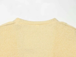 Close-up of back neckline showing vintage chunky knit texture and soft beige fabric