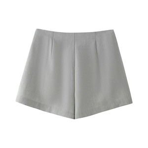 Detailed view of high-waist grey tailored suit shorts with fine texture and front pleats