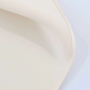 Detail shot of cream twill fabric with visible diagonal texture and fine double stitching