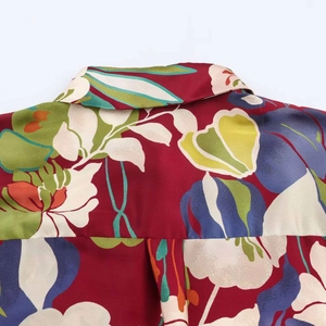 Detailed close-up of the vintage floral print and satin texture on the shirt's collar
