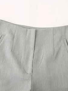 Detail of light grey high-waisted shorts with hidden closure and side pockets