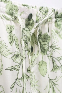 Détail du pantalon d'été avec imprimé feuilles vertes et taille élastique à cordon