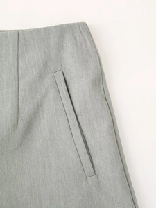 Close-up of high-waisted shorts featuring diagonal pockets and premium woven texture
