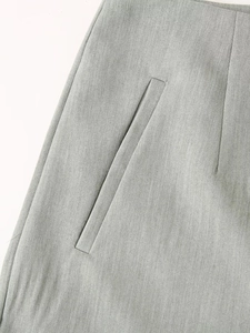 Macro detail of side pocket and high-quality fabric texture on light grey women suit pants