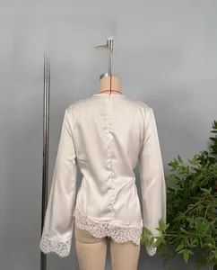 Detailed back view of white satin top featuring delicate lace trim and invisible zipper