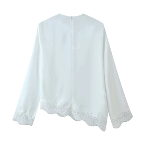 Detail of white chiffon top showing asymmetrical lace hem and back hidden zipper closure