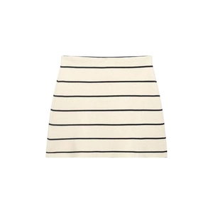Detailed close-up of cream knit mini skirt with black stripes and fine textured stitching