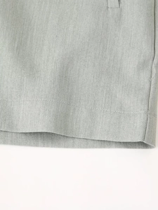 Close-up of the woven fabric texture and stitching detail on high-waist shorts