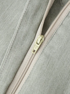 Macro shot of high-quality twill fabric texture and durable metal zipper on women's set