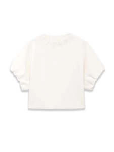 Detailed view of white knit fabric texture and puff sleeves on the elegant woman top