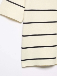 Detail of the high-quality knit texture on the beige and black striped sweater