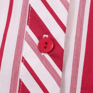 Close-up of a red and white striped shirt fabric with a red round button detail