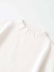 Detailed close-up of the white ribbed knit collar on this elegant women's sweater set