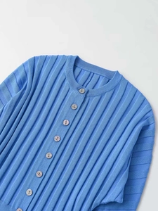 Detail of the sky blue knitted cardigan featuring vertical rib texture and light wood buttons
