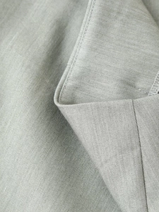 Detailed macro view of the grey suit jacket collar showing twill texture and stitching