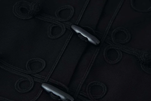 Macro shot of stylish toggle buttons and braided frogging on a dark short jacket