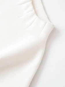 Macro shot of the ribbed elastic waist design on this white knit summer fashion set