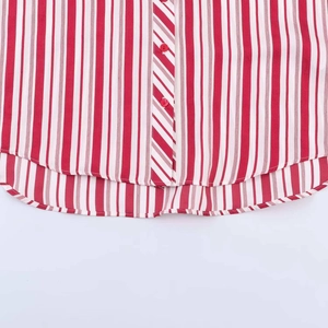 Detail of red and white striped shirt showing round resin buttons and curved hemline