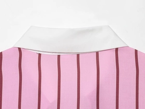 Close-up of contrast white polo collar and pink striped textured fabric on women's shirt
