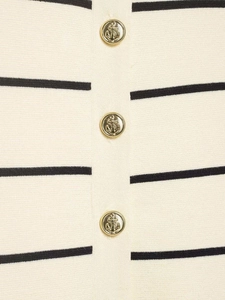 Detail of vintage gold anchor buttons on a beige and black striped knit cardigan