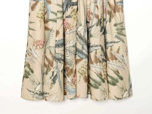Detail of floral and hummingbird print on linen-like fabric with elegant draping folds