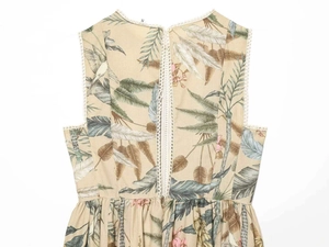 Detail view of tropical floral print dress with white lace trim and back invisible zipper