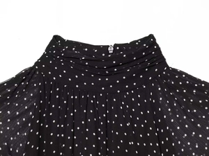Detailed view of high neck pleated polka dot chiffon dress with back hidden zipper