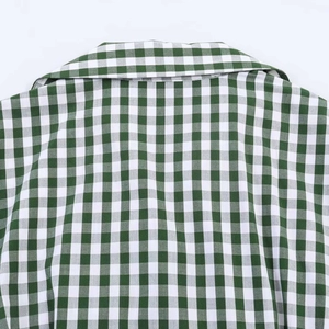 Detail of the green gingham shirt dress showing the neat collar and breathable cotton fabric