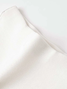 Detailed macro view of the premium white knitted texture on the stylish suit fabric