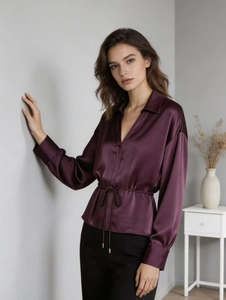 Detailed texture of dark purple satin shirt featuring a V-neck and adjustable waist drawstring