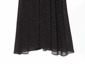 Detail of polka dot chiffon dress hem showing lightweight fabric and high-quality stitching