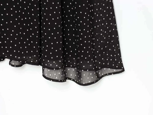 Detail of polka dot chiffon dress hem featuring clean stitching and inner lining