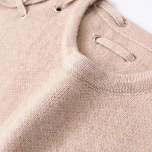 Minimalist knit tank top featuring lace-up shoulder detail and soft oatmeal texture