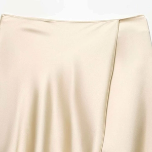Elegant champagne satin wrap skirt with a high-shine finish and overlapping waist detail