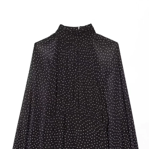Elegant polka dot chiffon dress featuring a high pleated neck and long sleeves in black