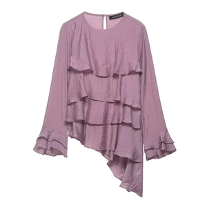 Detail of lavender asymmetrical long-sleeve top with triple-layered ruffle accents