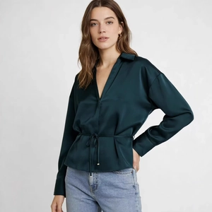 Deep green satin long-sleeve blouse with lapel V-neck and waist tie on light gray background