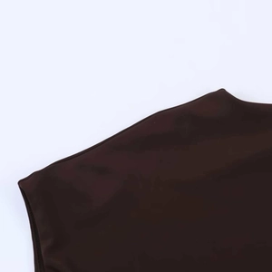 Detail shot of deep brown boat neck dress sleeve with smooth stretch fabric and clean seams