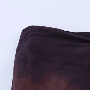 Detail shot of sheer dark purple fabric showing its fine texture and soft drape