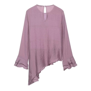 Detail of grey-purple pleated chiffon blouse with layered asymmetric hem and ruffled cuffs